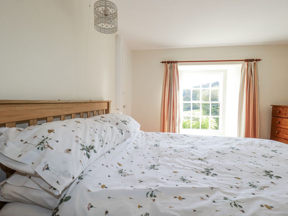 A bedroom with a bed and window at Tresarrett Manor in Bodmin