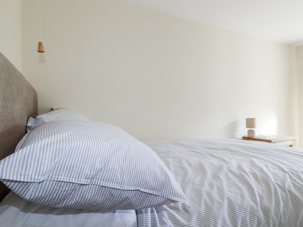 A bedroom with a bed and nightstand at Tresarrett Manor in Bodmin