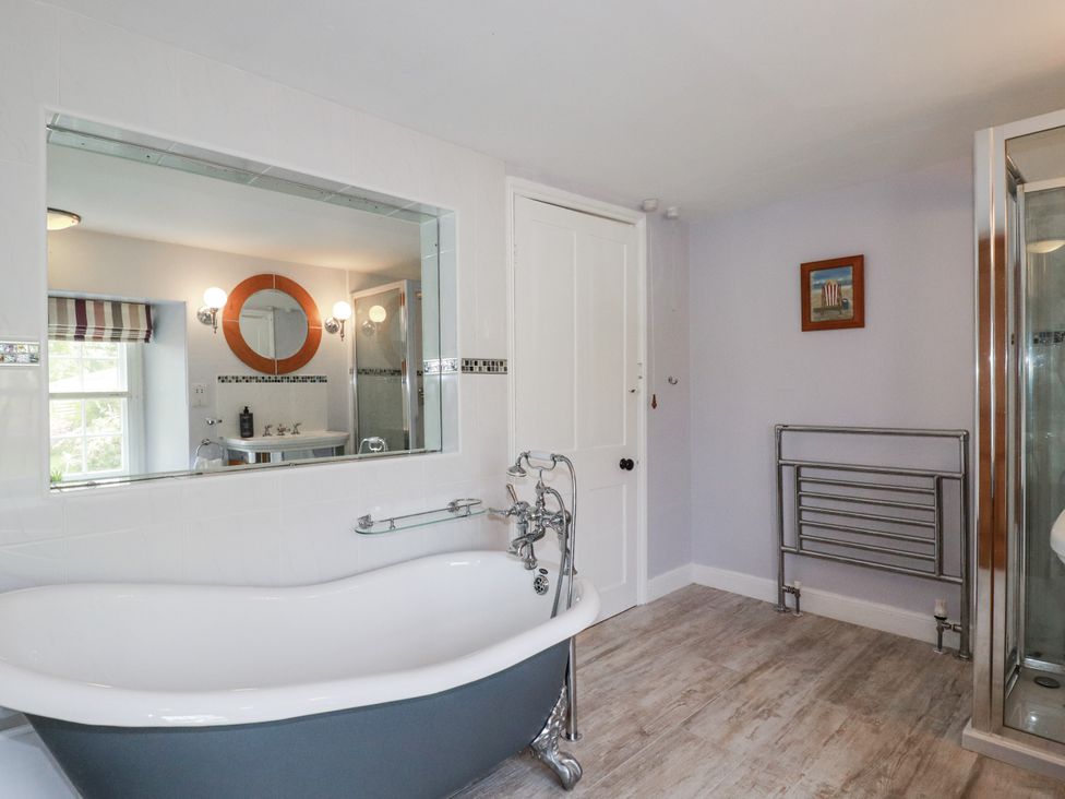 A bathroom with a bathtub and sink at Tresarrett Manor in Bodmin