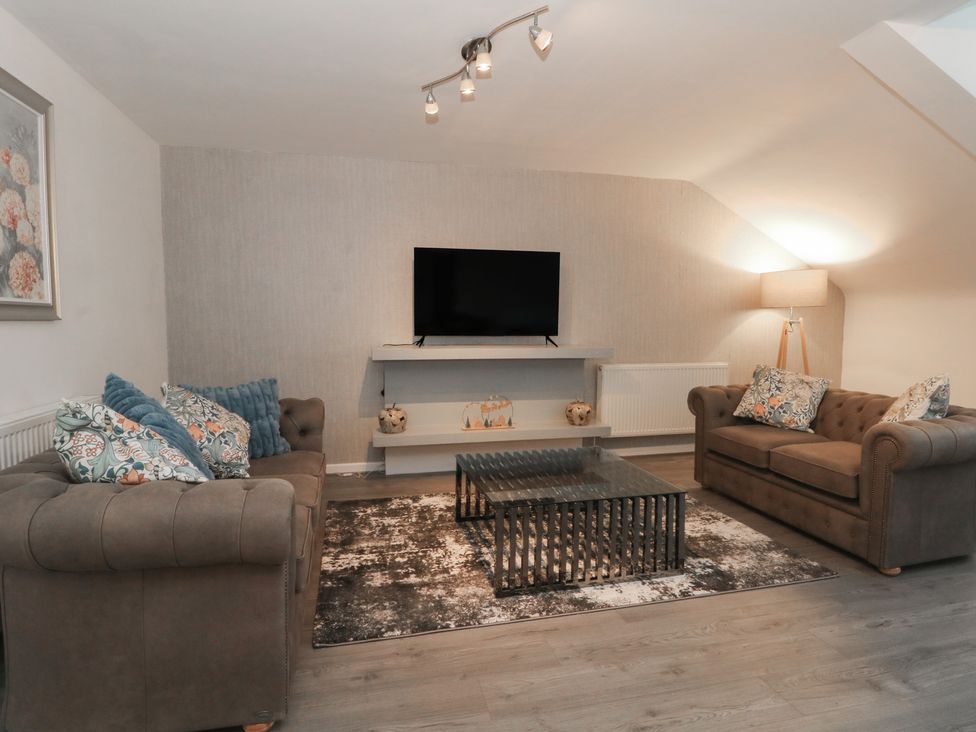 A living room with a television and a coffee table at 32B Bank Street, Rossendale