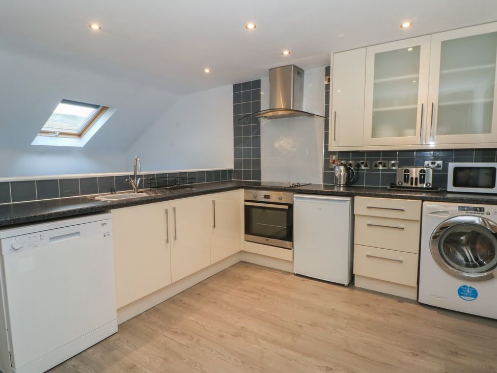 A kitchen with appliances and cabinets at 32B Bank Street, Rossendale