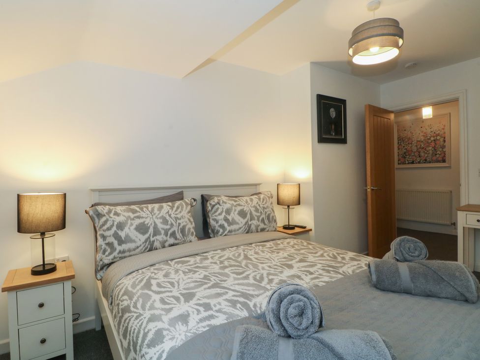 A bedroom with a bed and two nightstands at 32B Bank Street Rossendale