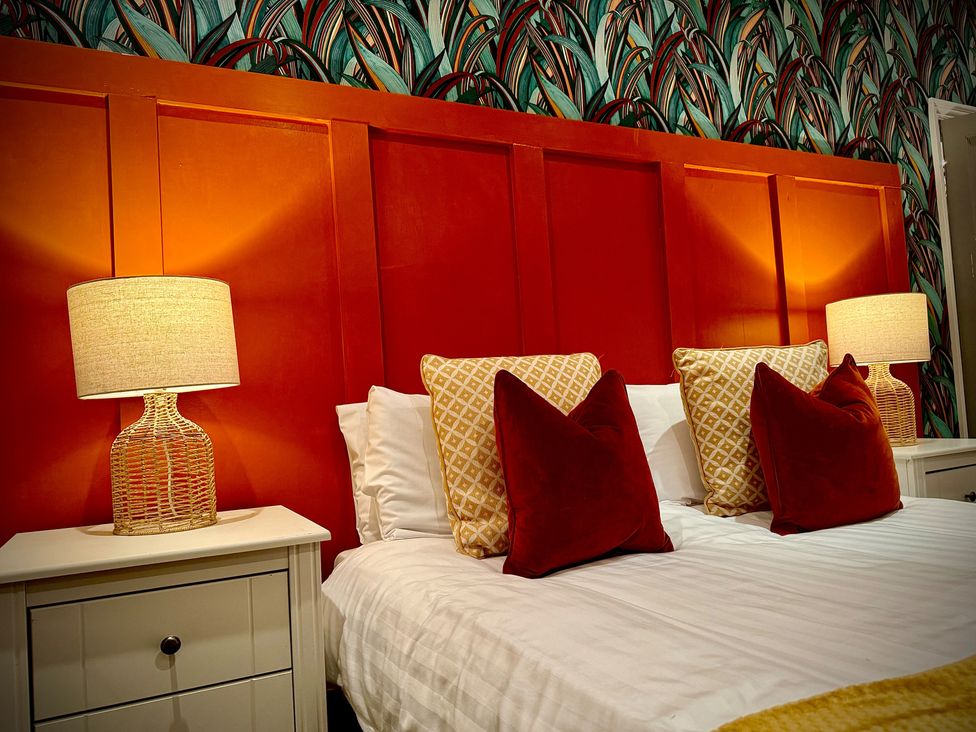 A bedroom with bed and lamps at Horncliffe Hot Tub House