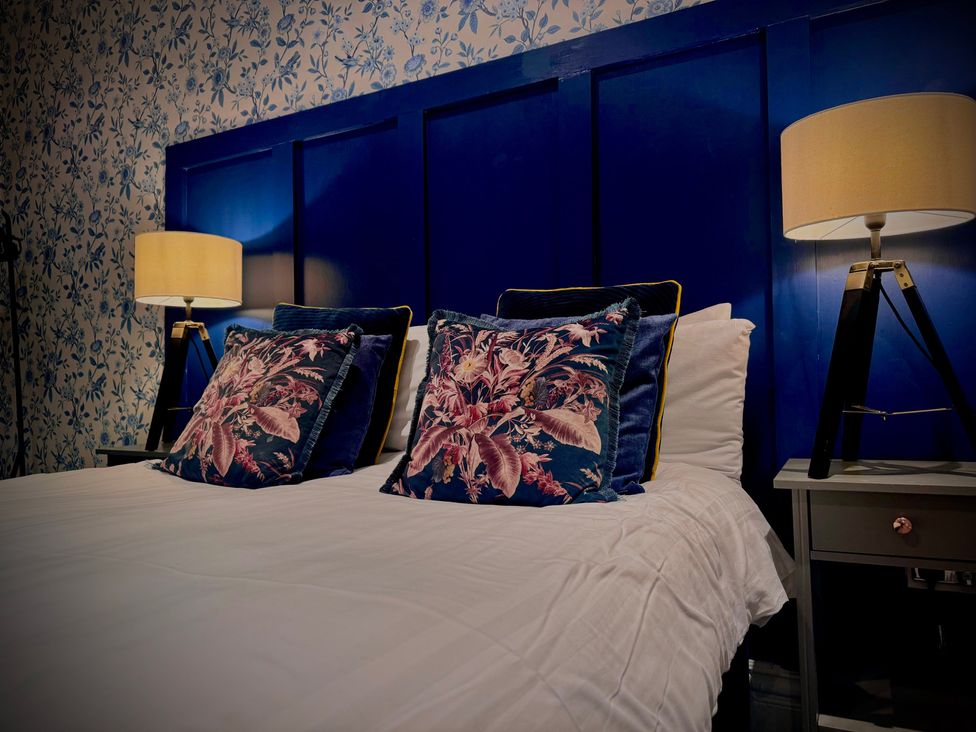 A bedroom with a bed and pillows at Horncliffe Hot Tub House