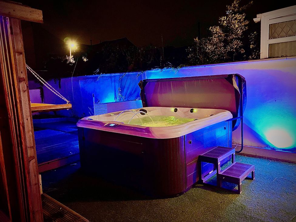 A hot tub in a garden with steps and outdoor lighting at Horncliffe Hot Tub House