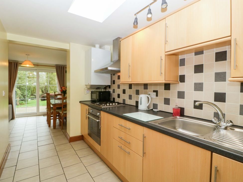 A kitchen with cabinets and countertops at Orchard Cottage in Corse near Gloucester