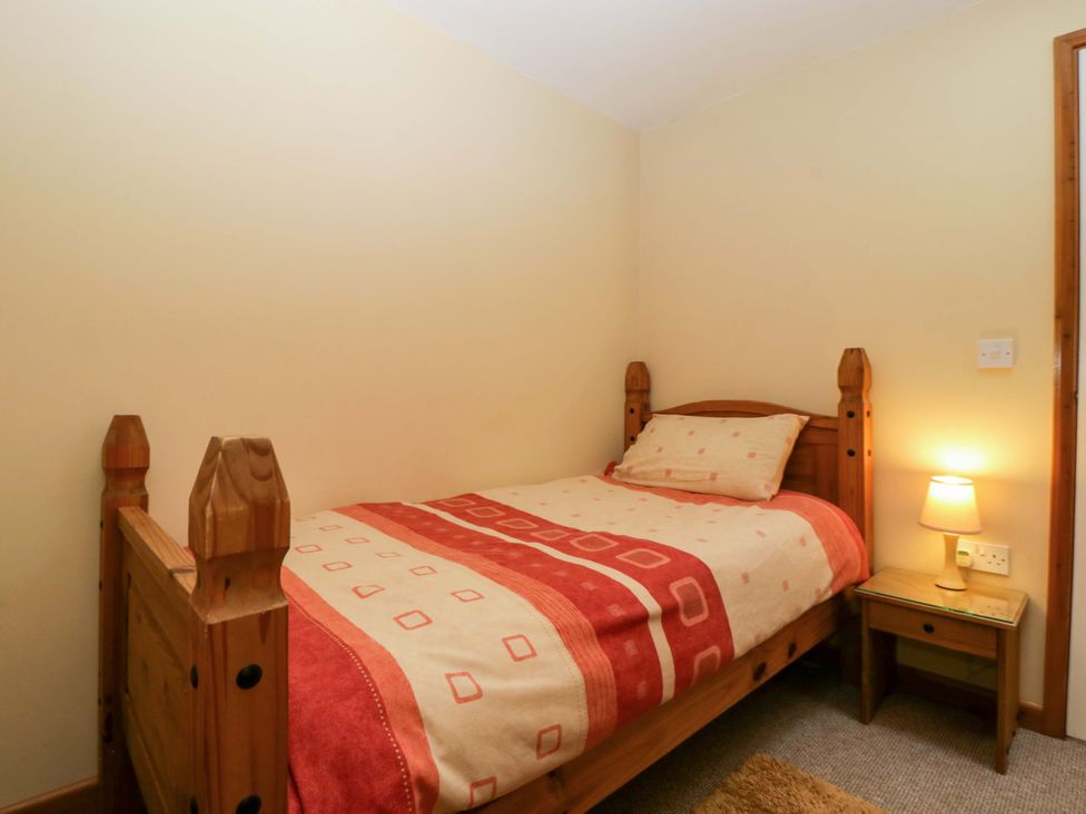 A bedroom with a single bed and bedside table at Orchard Cottage in Corse near Gloucester