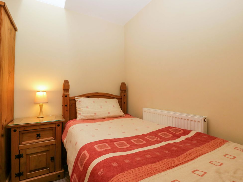 A bedroom with a single bed and nightstand at Orchard Cottage Corse near Gloucester
