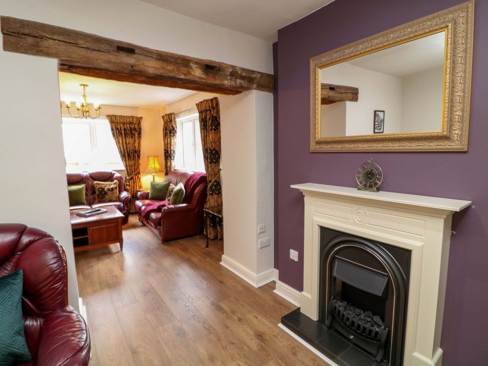 A living room with a fireplace and sofa at The Annex in Belper