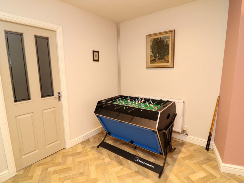 A game room with a foosball table and a door at The Annex in Belper