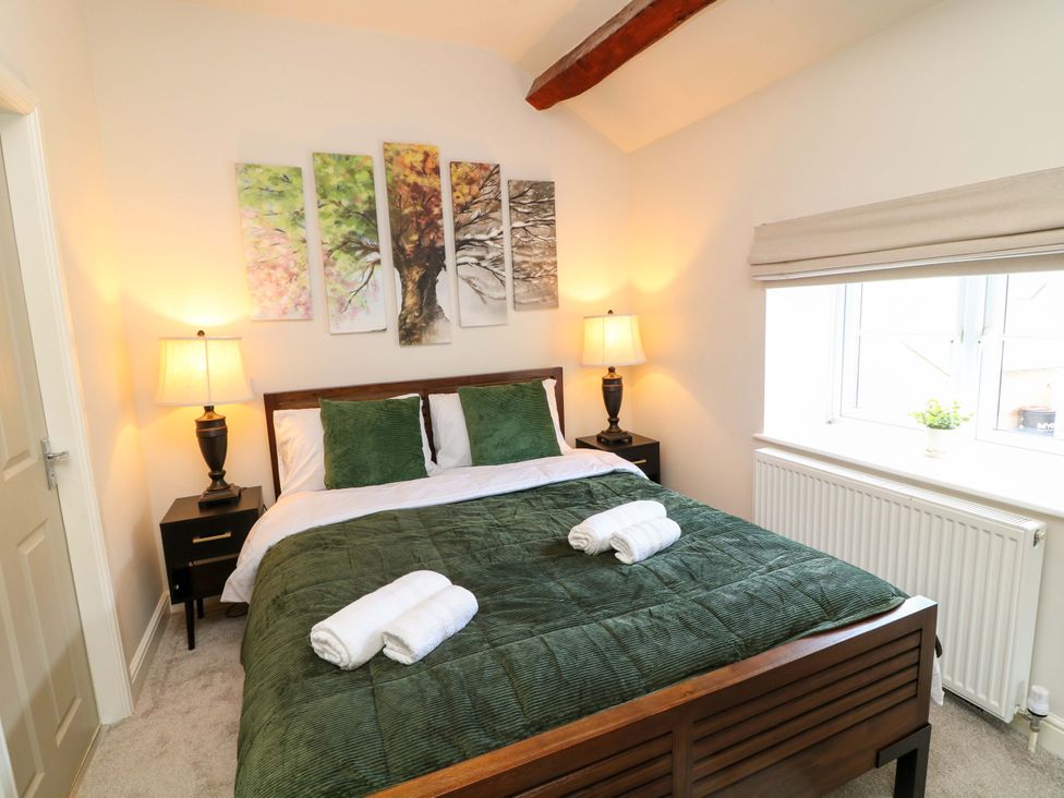 A bedroom with a bed and lamps at The Annex in Belper