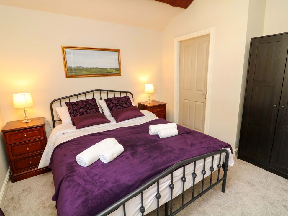 A bedroom with a double bed and bedside lamps at The Annex in Belper