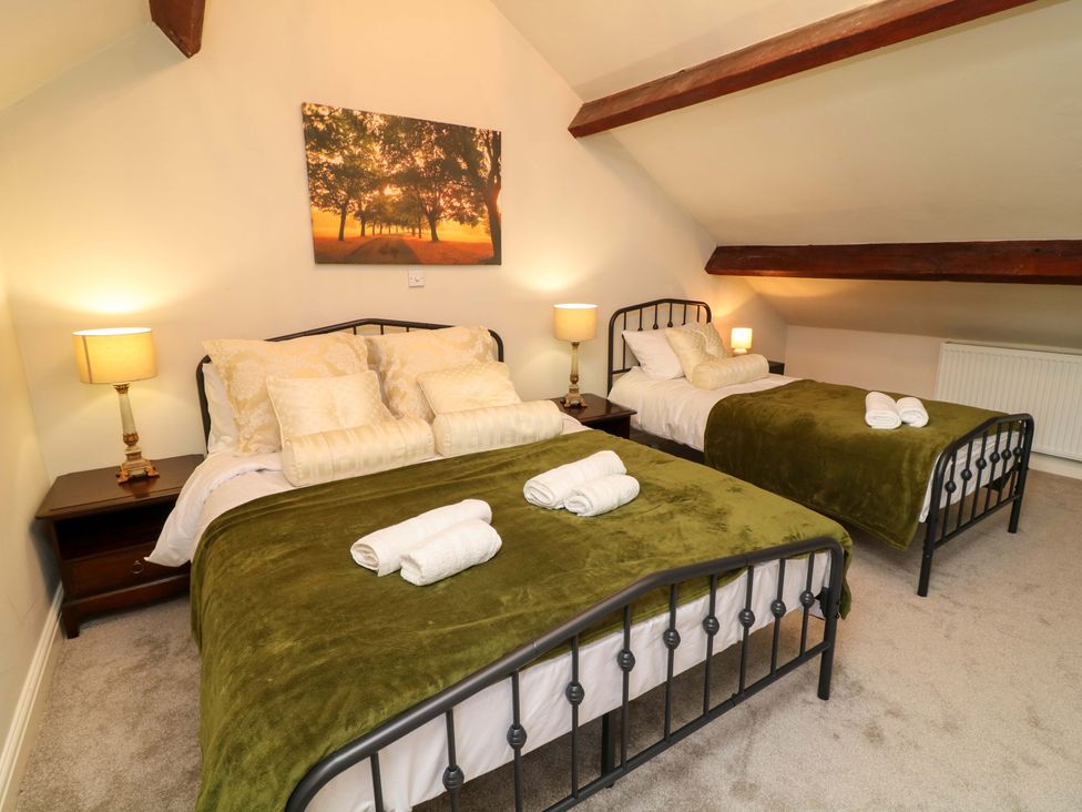 A bedroom with two beds and a painting at The Annex in Belper