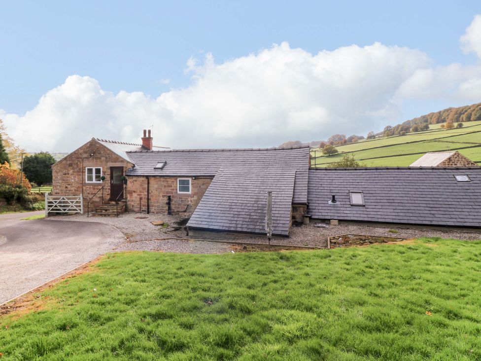 A house with a sloped roof and grass in front at The Annex in Belper