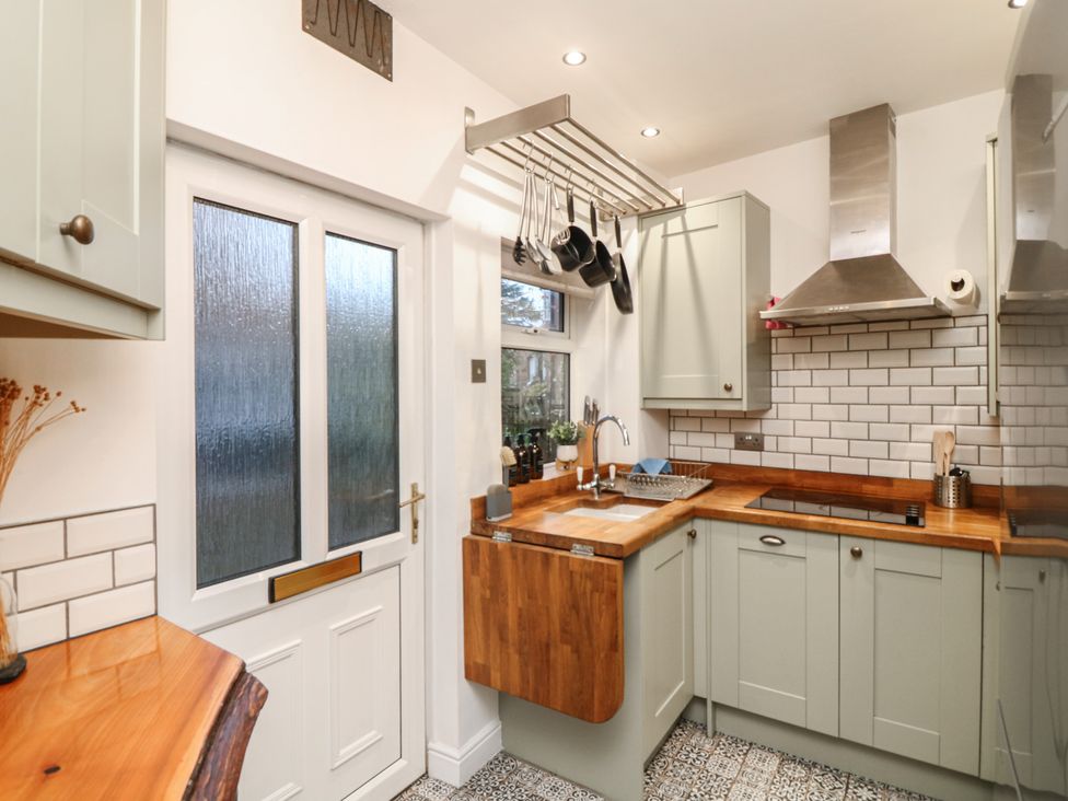 A kitchen with a sink and cooking hob at 1 Nottingham Road Southwell