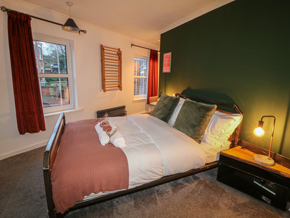 A bedroom with a bed and window at 1 Nottingham Road in Southwell