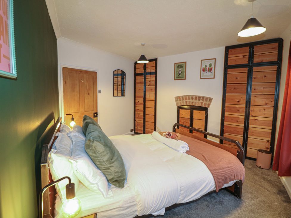 A bedroom with a bed and storage at 1 Nottingham Road in Southwell