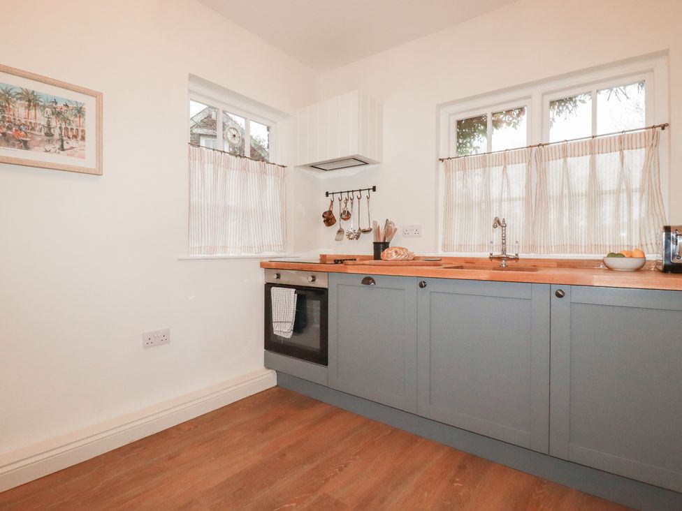 A kitchen with countertops and appliances at Copper Mine Cottage in Bodmin