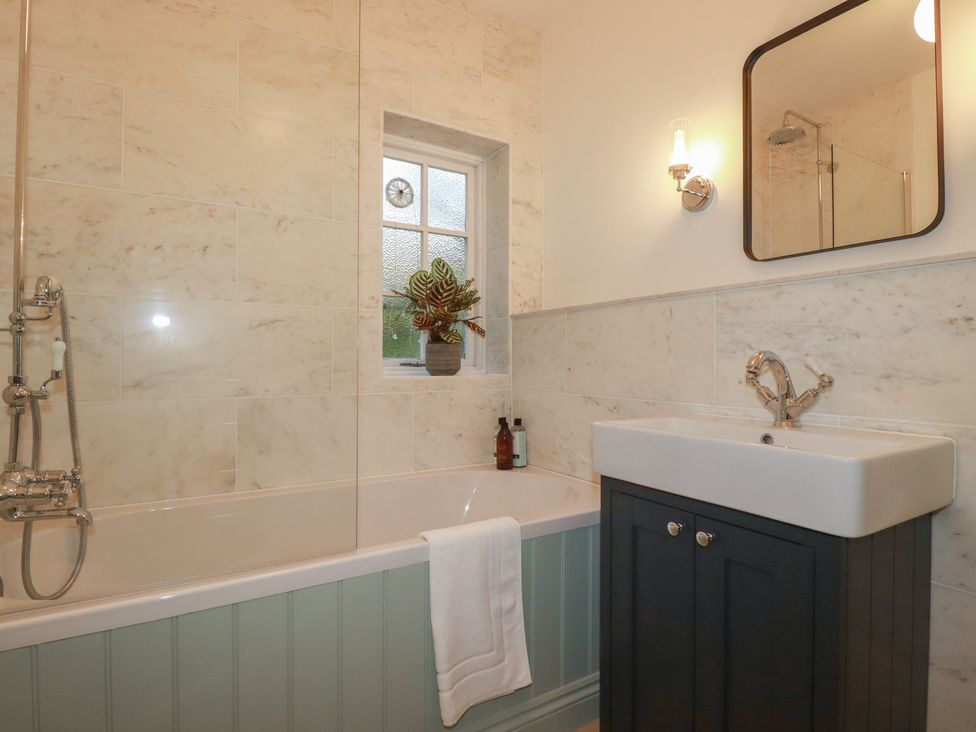 A bathroom with a bathtub and sink at Copper Mine Cottage in Bodmin