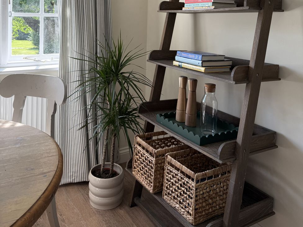 A dining room with shelves and a table at Copper Mine Cottage Trelill near Port Isaac