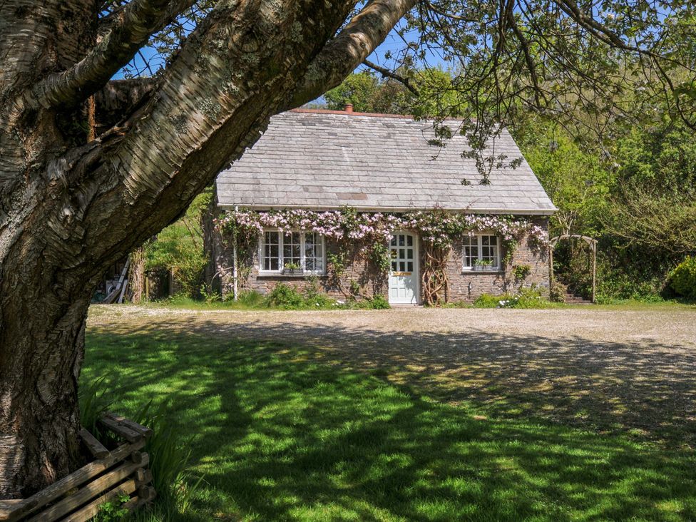 A cottage with a garden and trees at Copper Mine Cottage in Trelill near Port Isaac