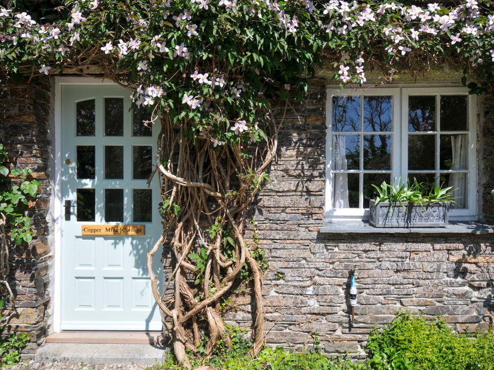 The entrance with a door and window at Copper Mine Cottage in Trelill near Port Isaac
