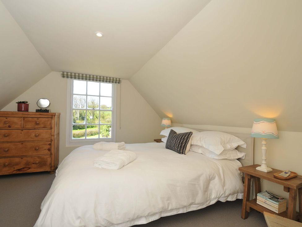 A bedroom with a bed and a dresser at Copper Mine Cottage Trelill near Port Isaac