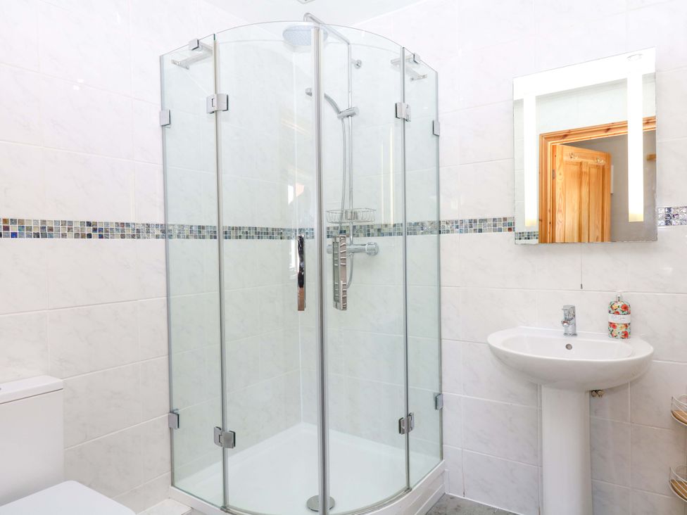 A bathroom with a shower and sink at The Milk Shed in Plymtree