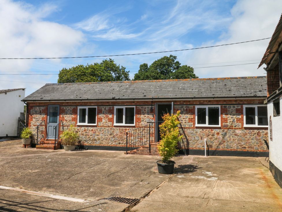 A building with stone walls and steps at The Milk Shed in Plymtree