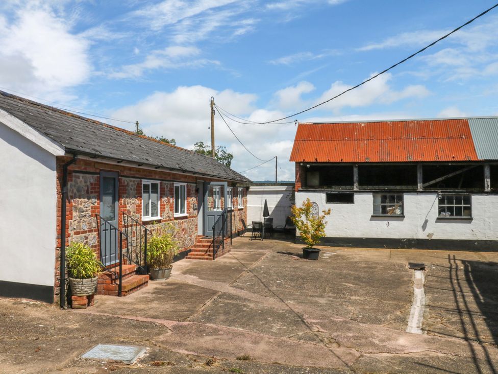 An outdoor area with buildings and plants at The Milk Shed in Plymtree