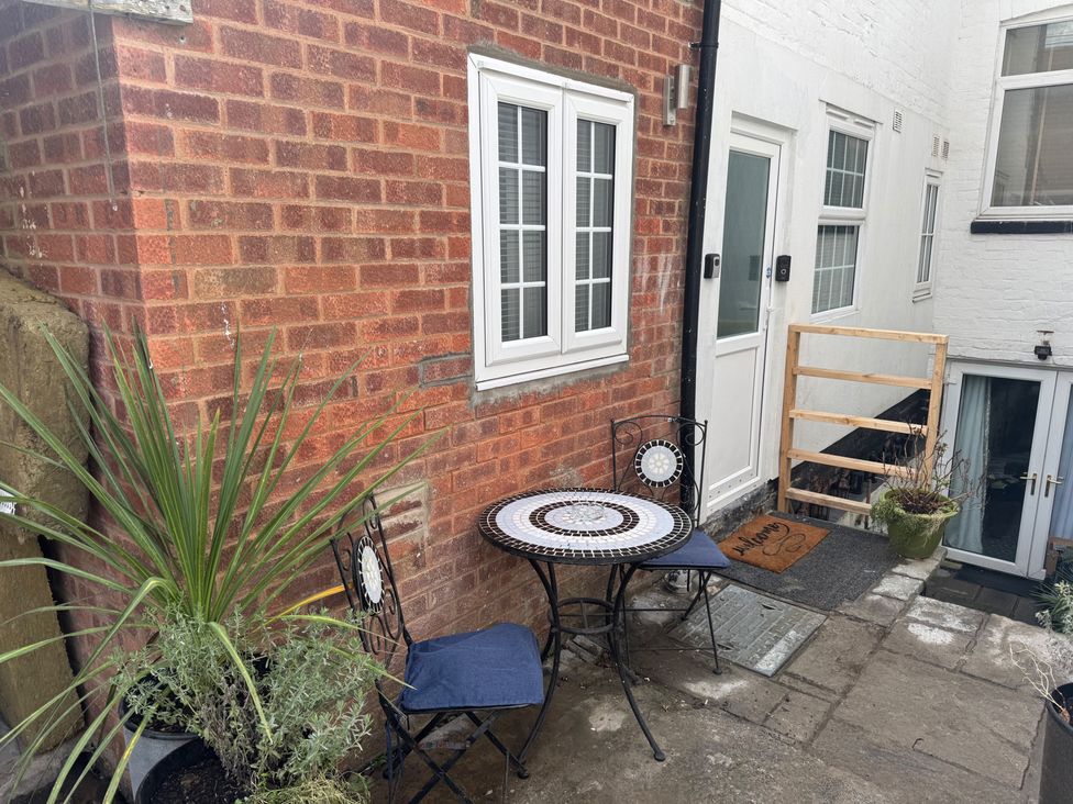 An outdoor seating area with a table and chairs at The Old Barn in Manchester