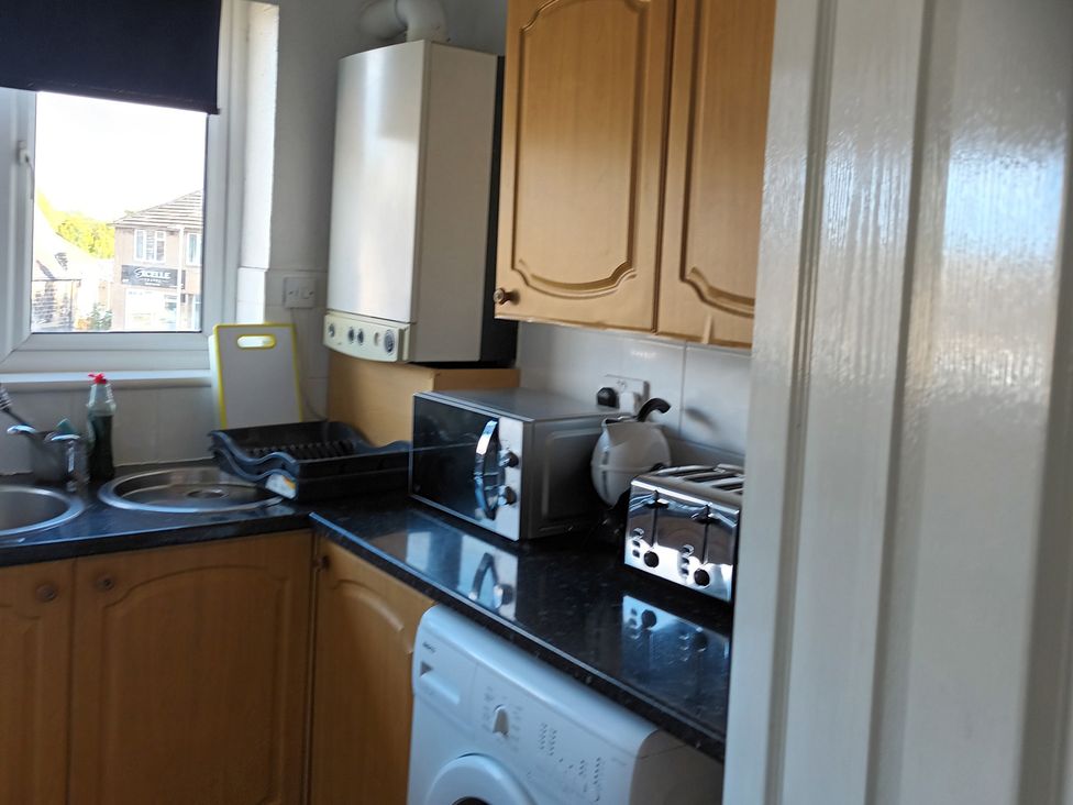 A kitchen with appliances and a window at 11 Kings Court in 