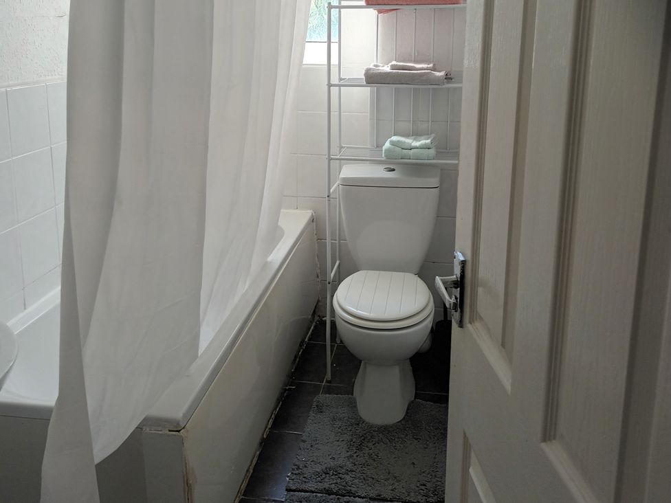 A bathroom featuring a bathtub and a toilet at 11 Kings Court
