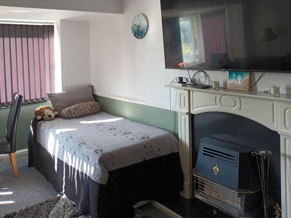 A bedroom with a bed and television at 11 Kings Court