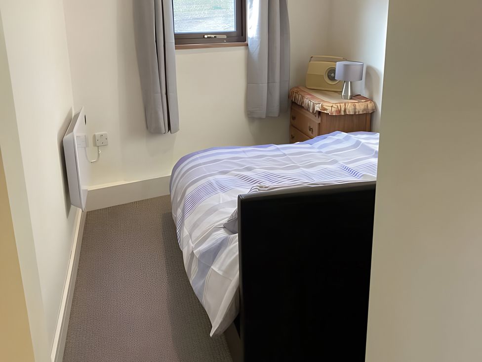 A bedroom with a bed and a dresser at The Nook in 