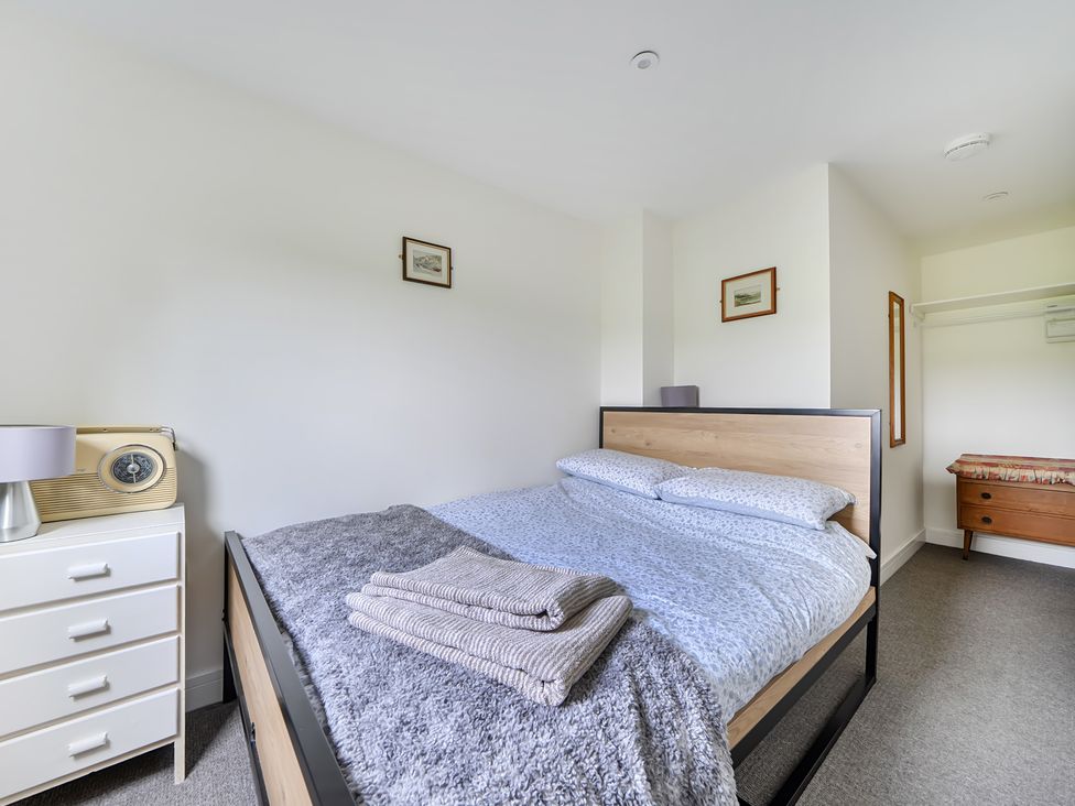 A bedroom with a bed and dresser at The Nook in Praa Sands