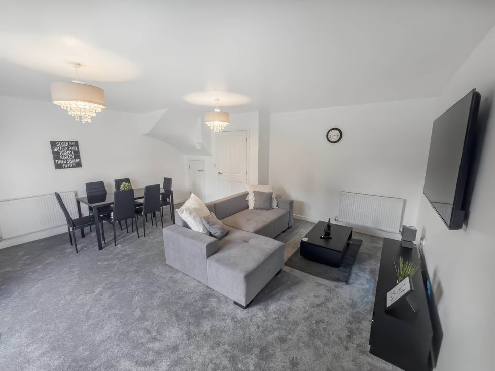 A living room with a sofa and dining table at the property