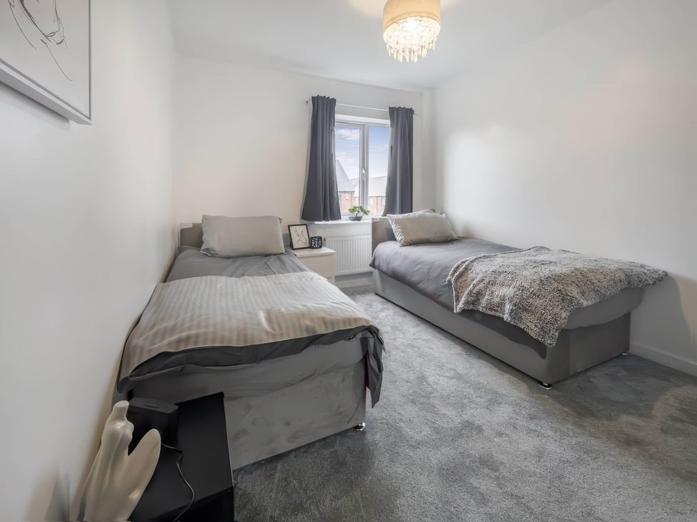 A bedroom with two beds and a window at The Old Barn in Manchester