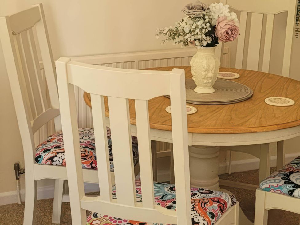 A dining room with a table and chairs at 
