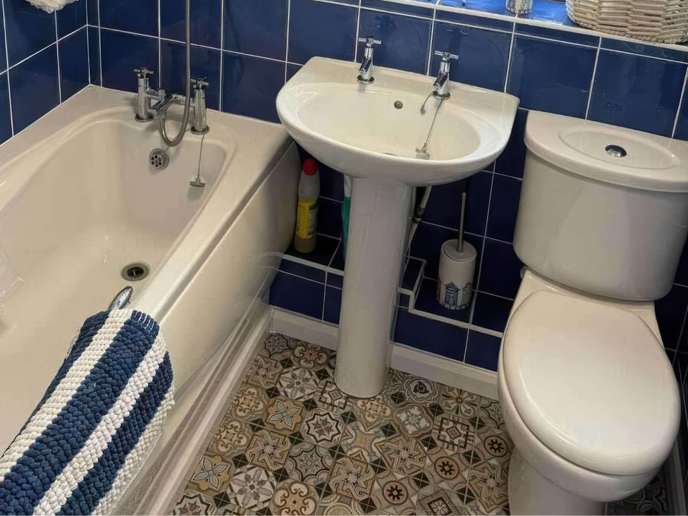 A bathroom with bathtub, sink, and toilet