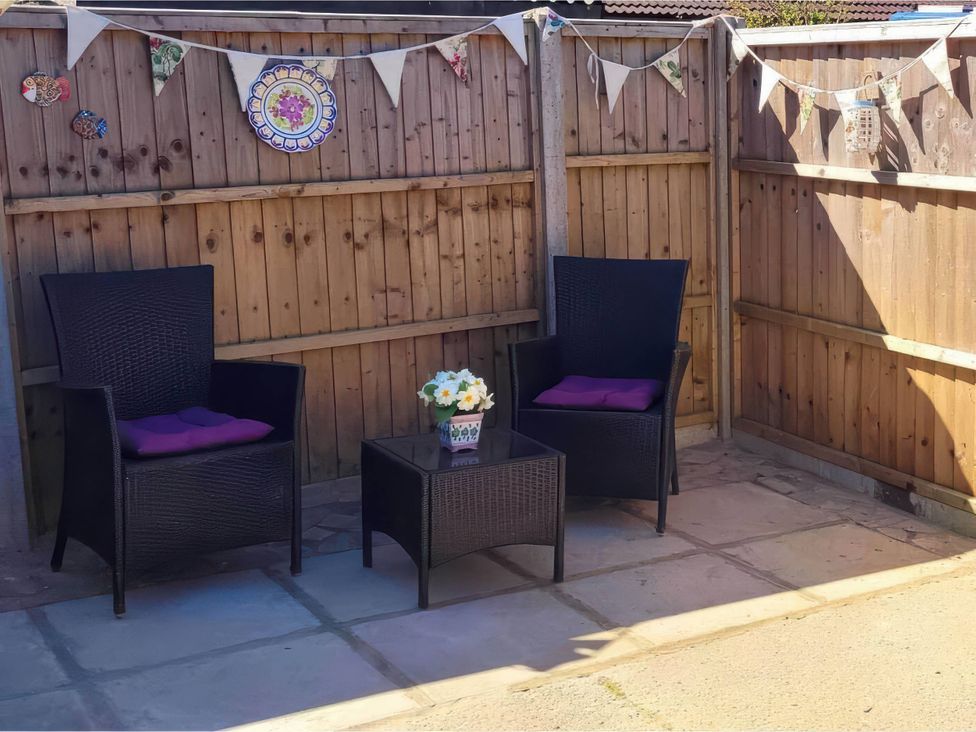 A garden seating area with two chairs and a table at 