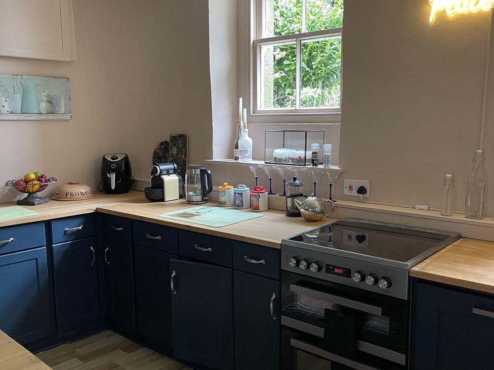 A kitchen with various appliances and a fruit bowl at High Dyke Cottage