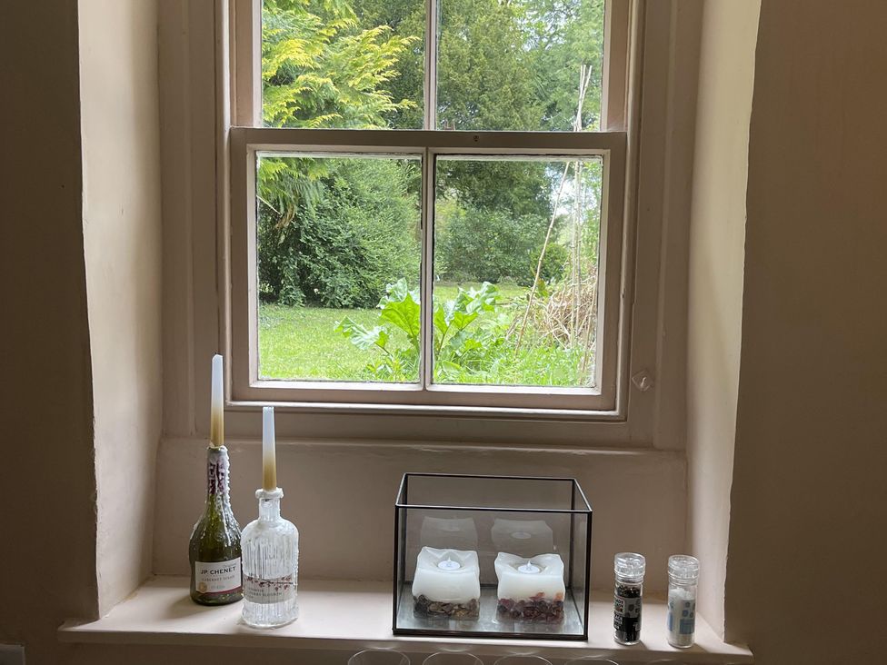 A window with candles and bottles at High Dyke Cottage