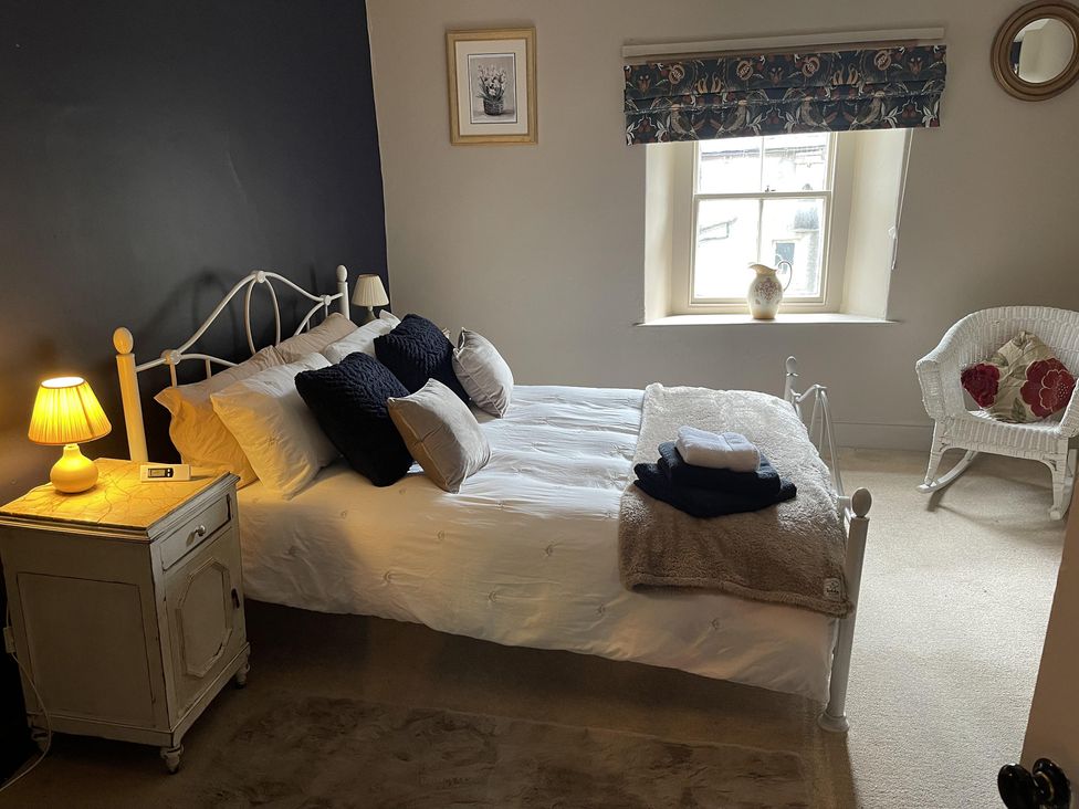 A bedroom with a bed and lamp at High Dyke Cottage in 