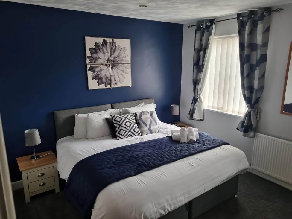 A bedroom with a bed and bedside table at The Old Barn in Manchester