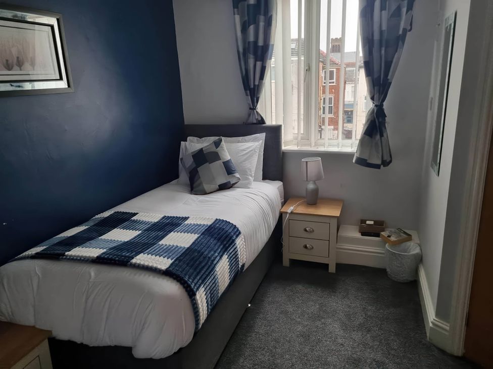 A bedroom with a single bed and a bedside table at the property in unspecified location