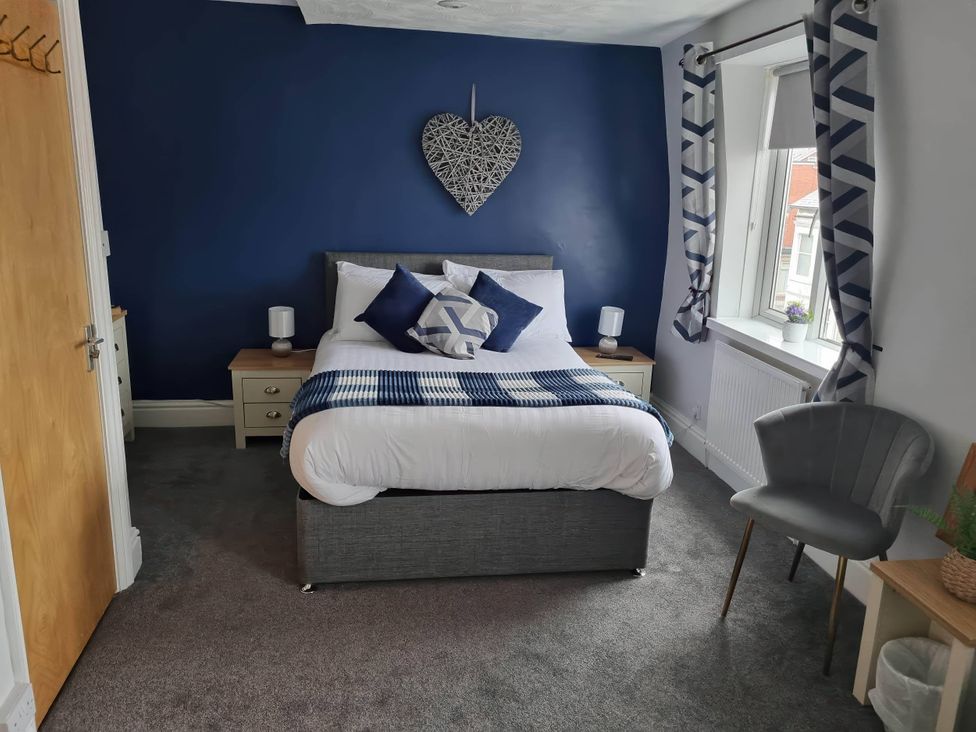 A bedroom with a bed and nightstand at 