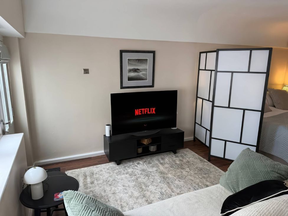 A living room with a television displaying Netflix at an unspecified location