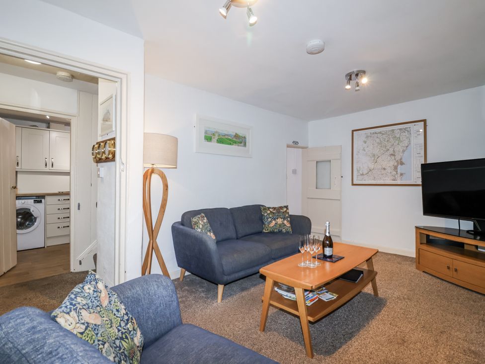A living room with a sofa and coffee table at Orchard Cottage in Dawlish