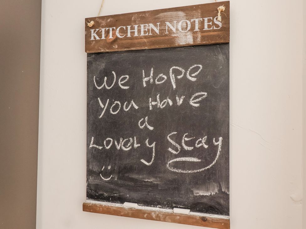 A chalkboard with a welcome message at Orchard Cottage Dawlish